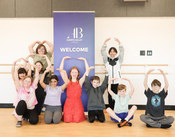 Students posed with AB Banner Ages 10 12